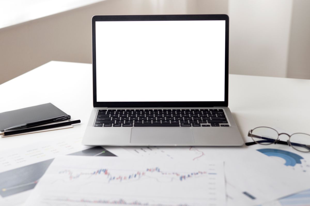 Laptop and financial documents on a desk